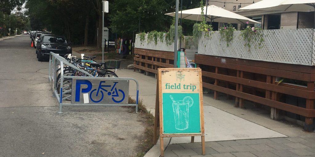 A bike corral is located on the street