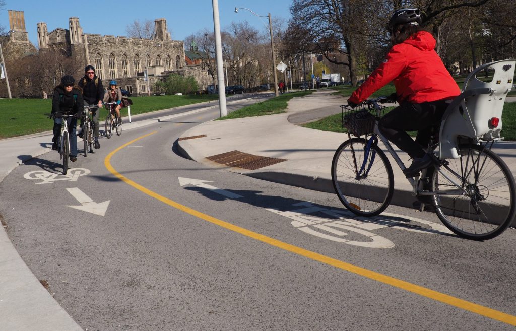 People cycle in opposite directions along a two-way cycle track