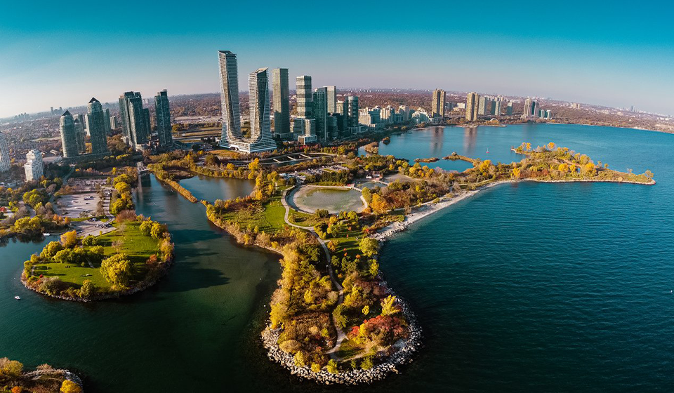Aerial of peninsula into lake with towers in background